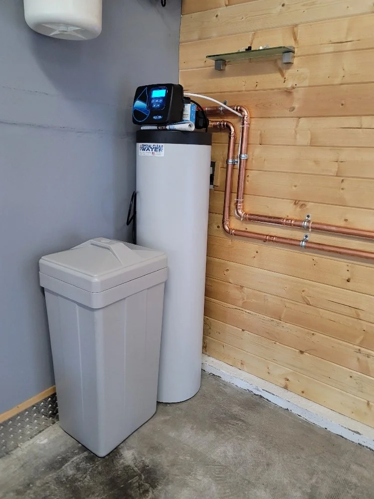 Water softener installed in a garage utility area
