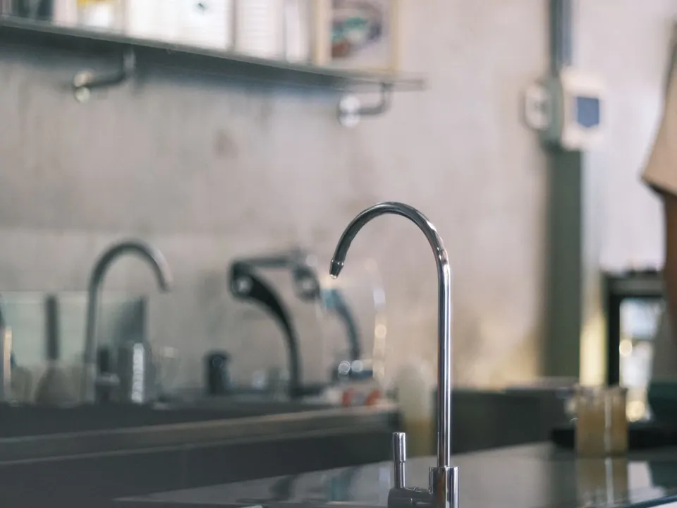 Filtered-water faucet installed beside a kitchen sink